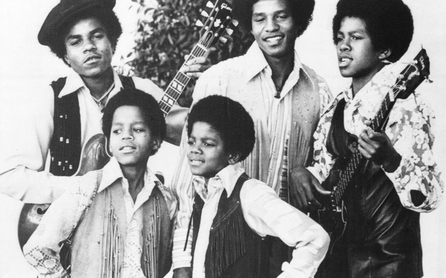 The Jackson 5, Michael Jackson, front right; Marlon Jackson, front left; Tito Jackson, back left; Jackie Jackson, back center; and Jermaine Jackson, back right; pose for this undated photo together in Los Angeles.