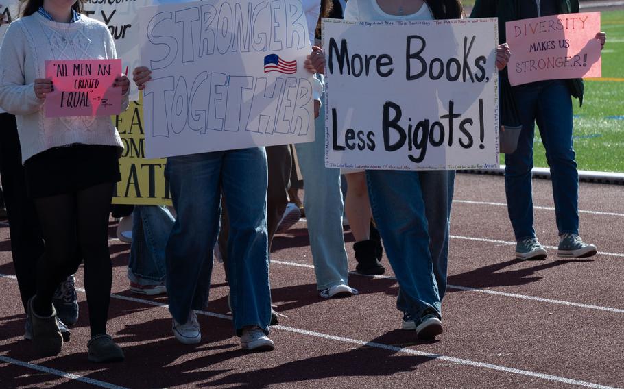 Students hold up protest signs