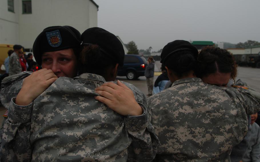 Spc. Autumn Richardson, left, is consoled by friend and fellow soldier Pfc. Monique Fernandez as a bus carrying Richardson’s boyfriend, Spc. Jared Foulk, left on the first leg of a journey to Iraq. Foulk’s unit, the 596th Maintenance Company, left Monday for a one-year deployment. Richardson, 23, is pregnant with Foulk’s child and said she worried that Foulk might not return home. “I just want his baby to be able to know his father,” she said. On the right, Pvt. Jessica Lind, with beret, consoles Spc. Danielle Marsha, whose husband, Sgt. Brad Marsha, also left with the 596th. More than 200 596th Soldiers left Monday, and about three dozen will join them in about two months. 