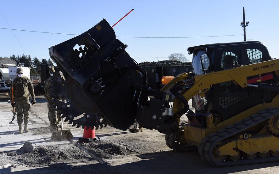 Airmen prepare to cut out a damaged section of concrete during a runway repair drill at Yokota Air Base.