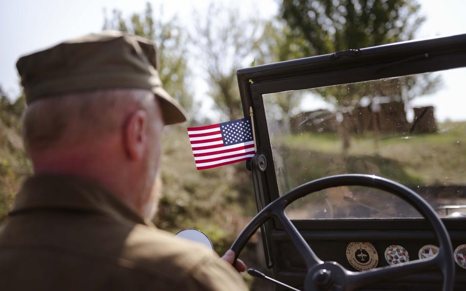 A Czech man drives to a bomber crash site in an original World War II vehicle during the 80th commemoration of the Battle over the White Carpathians in the Czech Republic on Sept. 1, 2024.