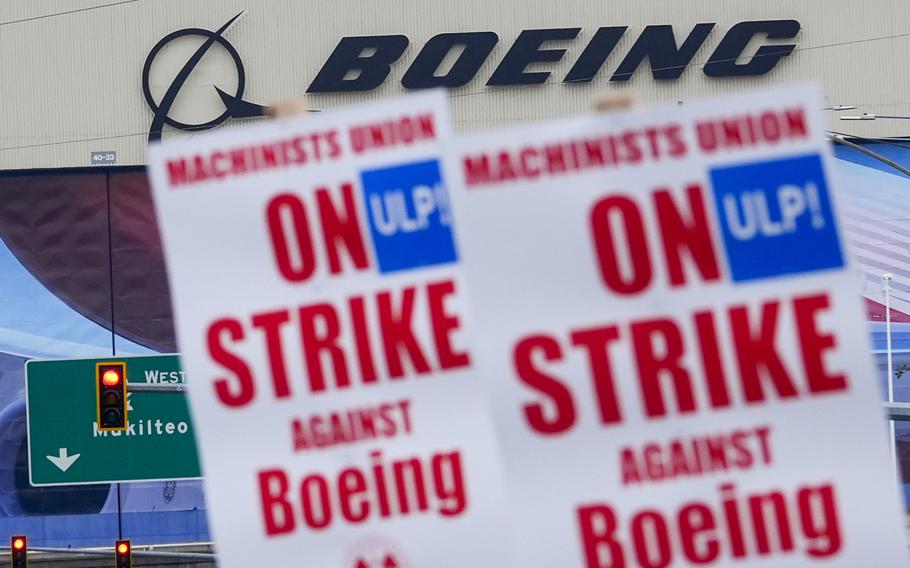 Boeing workers wave picket signs