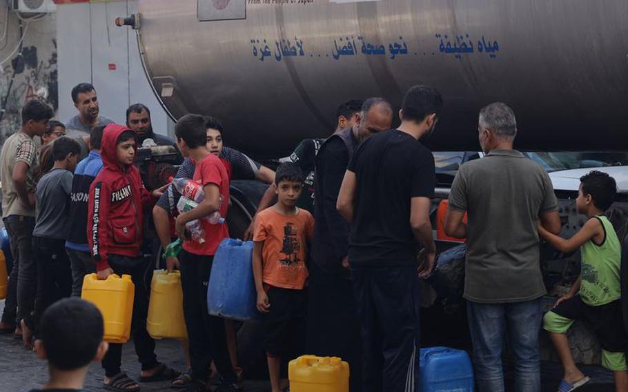 Drinking water is distributed to residents and displaced people in Rafah in the south of the Gaza strip.