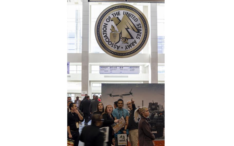 Attendees stop to look at an exhibition map