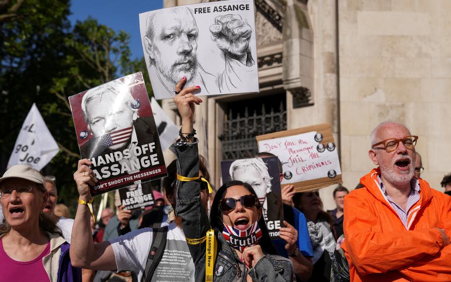 Protesters appear outside the court on the day of an extradition hearing of WikiLeaks founder Julian Assange in London, May 20, 2024. 
