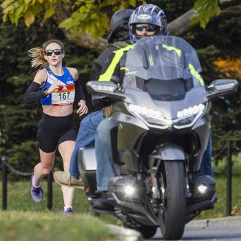 Tessa Barrett of Arlington, VA., follows a motorcycle escort 