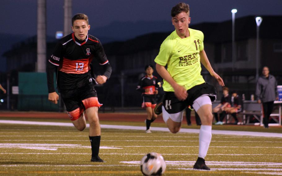 Matthew C. Perry's James Williams dribbles upfield against E.J. King's Kai Sperl during Friday's DODEA-Japan soccer match. The Samurai won 5-1.