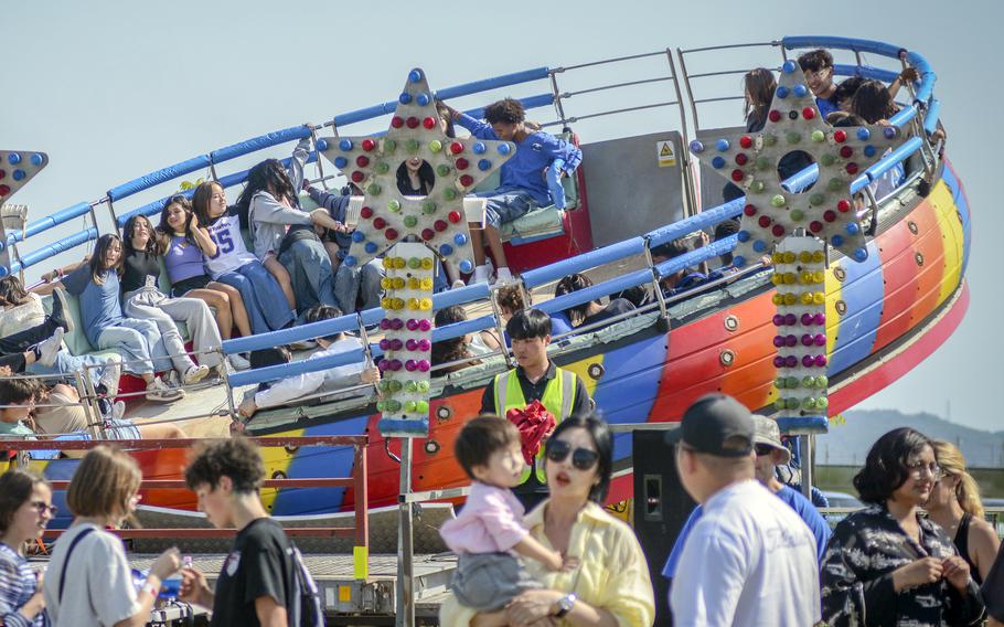 The Disco Pang Pang carnival ride spins people around during Spring Fest at Camp Humphreys, South Korea, May 18, 2024.