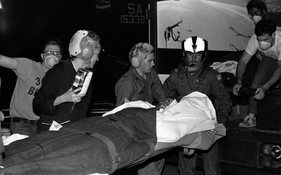 A burn victim is carried onto a helicopter