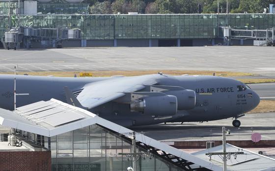 A U.S. military plane sits on a tarmac.