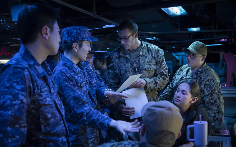 U.S. and Japanese sailors discuss Tomahawk missile procedures aboard the guided-missile destroyer USS McCampbell during training at Yokosuka Naval Base, Japan, on March 28, 2024.