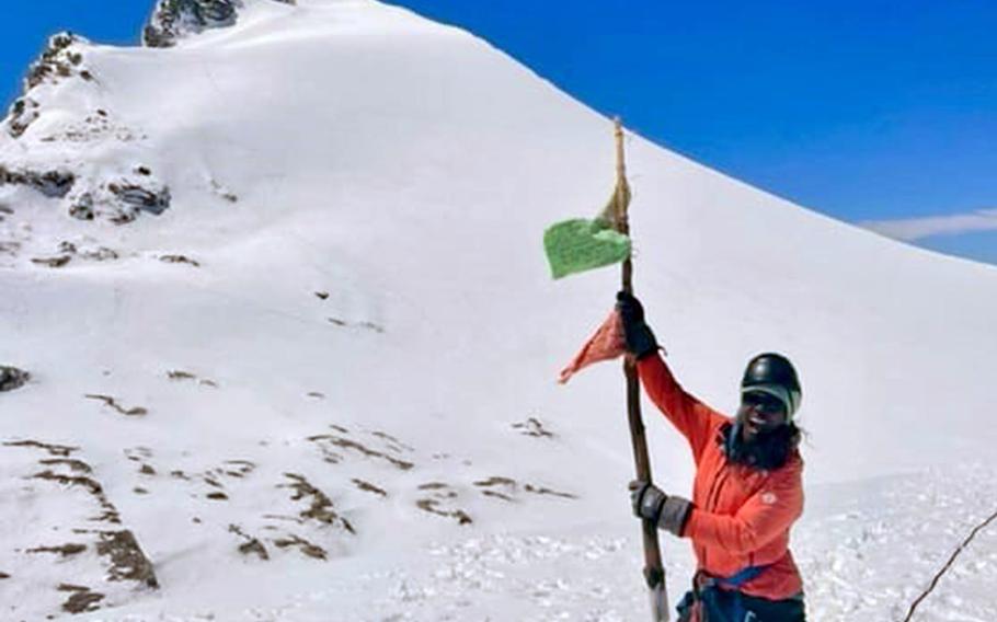 Ladeania Jackson climbs a snowy mountain.