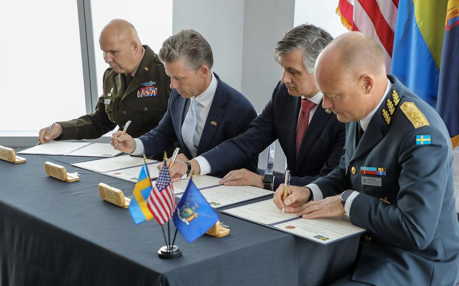 Leaders from the New York National Guard and the Swedish military sign an agreement for joint training at New York’s Freedom Tower on July 12, 2024. From left, Maj. Gen. Ray Shields, left, the adjutant general of New York; Pål Jonson, Sweden’s defense minister; Marcos Soler, New York’s deputy secretary for public safety; and Maj. Gen. Johan Pekkari, Sweden’s chief of policy and plans, sign the document.