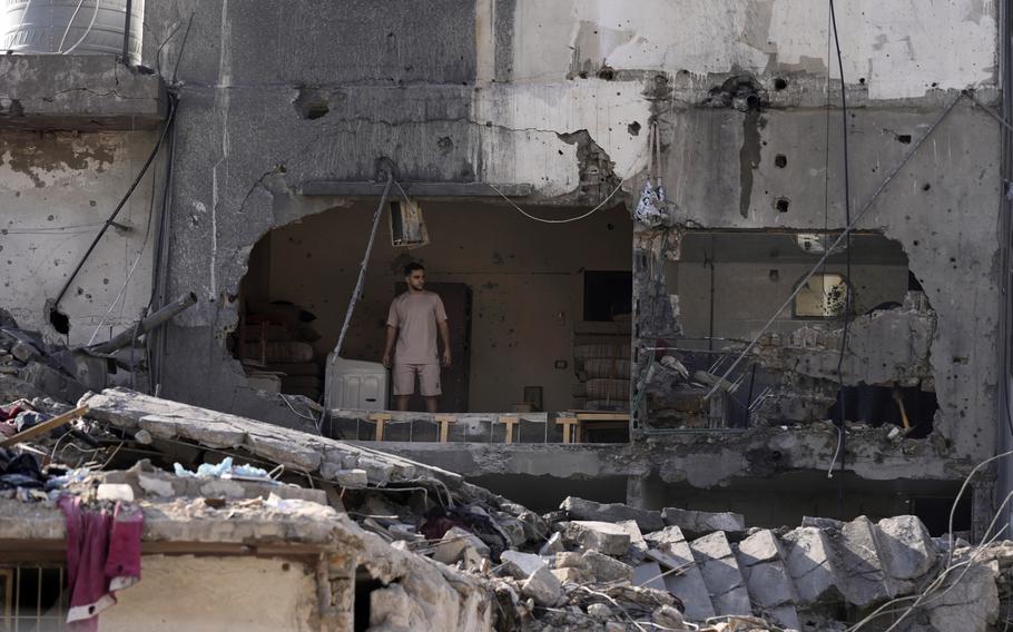 A destroyed house in Lebanon, with a man standing and surveying the damage in the middle, Oct. 30, 2024.