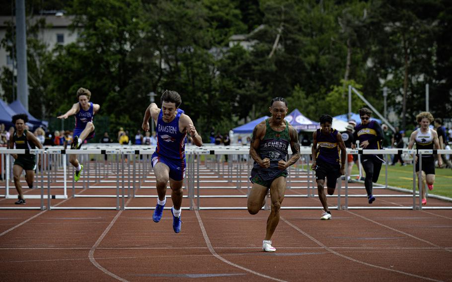 AFNORTH’s Connor Luminarias celebrates as he crosses the finish line, with Ramstein’s Vincent Studer close behind, during the boys 110 meter hurdles race at the 2024 DODEA European Championships at Kaiserslautern High School in Kaiserslautern, Germany, on May 24, 2024. Both athletes achieved personal records, with Luminarias winning the race with 15.52 seconds.