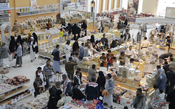 People shop in a supermarket in Sanaa, Yemen, before the Eid holiday on Saturday, June 15, 2024. (AP Photo/Osamah Abdulrahman)