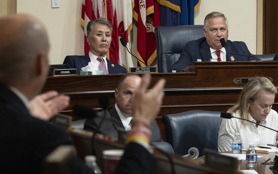 Reps. Mike Bost, R-Ill., and Mark Takano, D-Calif., listen during a House hearing.