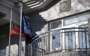 FILE - Lithuanian and European Union flags fly outside the Lithuanian Embassy in Beijing, Dec. 16, 2021. The U.S. State Department has set up an eight-person team known as the "firm" to provide help to countries cut off from Chinese trade. The team emerged after Washington stepped in to help Lithuania when the northern European country found its cargo shipments to and from China stranded two years ago during a feud over Taiwan. (AP Photo/Mark Schiefelbein)