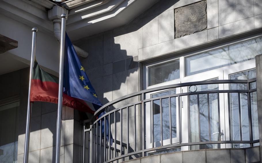 Lithuanian and European Union flags fly outside the Lithuanian Embassy in Beijing, Dec. 16, 2021.