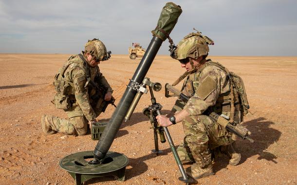 U.S. soldiers set up a mortar weapon in Syria.