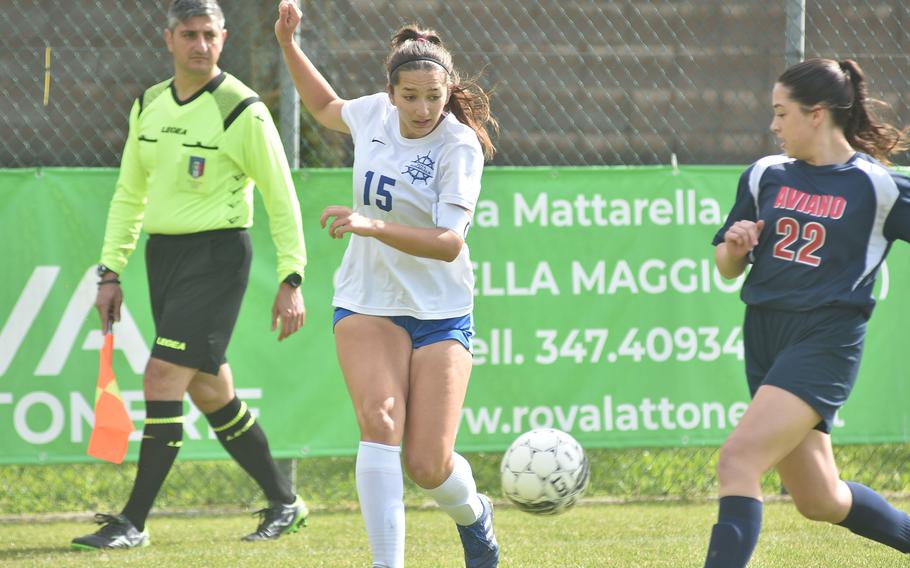 Rota’s Madison Lewis sends the ball toward the Aviano goal before the Saints’ Abigail Desporte can get to her in the Admirals’ 3-0 victory Saturday, April 27, 2024.