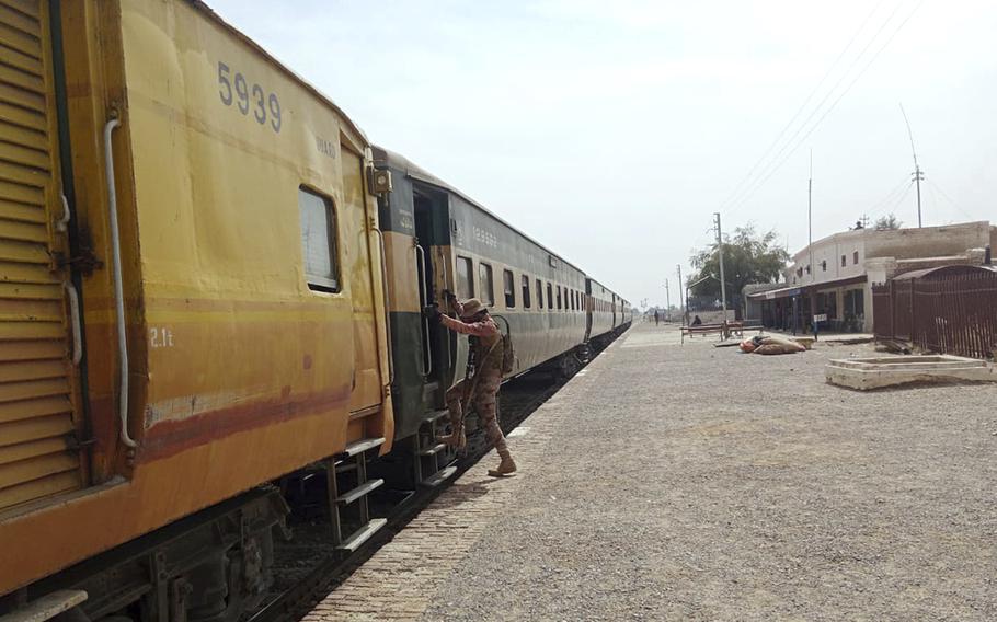 A soldier climbs the steps of a train car.