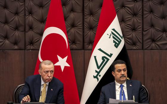 FILE - Iraq's Prime Minister Mohammed Shia al-Sudani, right, and Turkey's President Recep Tayyip Erdogan attend a meeting to sign mutual agreements in Baghdad, on April 22, 2024. The Iraqi government announced Tuesday July 23, 2024 an official ban on a Kurdish separatist group which has been engaged in a long-running conflict with Turkey. 