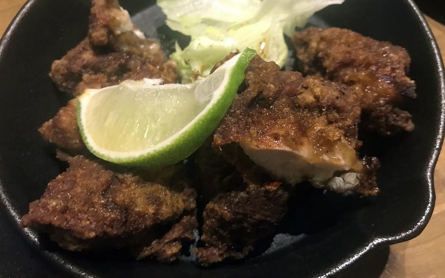 Panama Genjin Awase's tasty jerk fried chicken arrives at the table in a hot skillet.