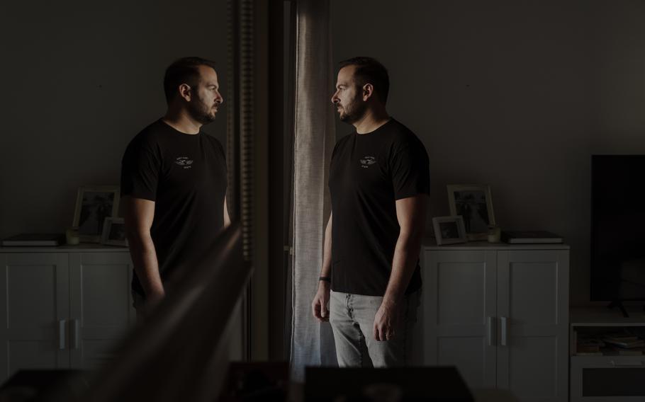 Ari Krauss, a reservist in Israel’s elite Golani Brigade, is reflected in a mirror at his home in Tel Aviv.