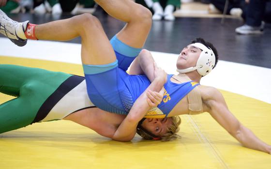 Kubasaki's Joshua Cope, voted the Rumble tournament's Outstanding Wrestler, uses a gut wrench to tilt St. Mary's Luke Kojima in the 127-pound final.