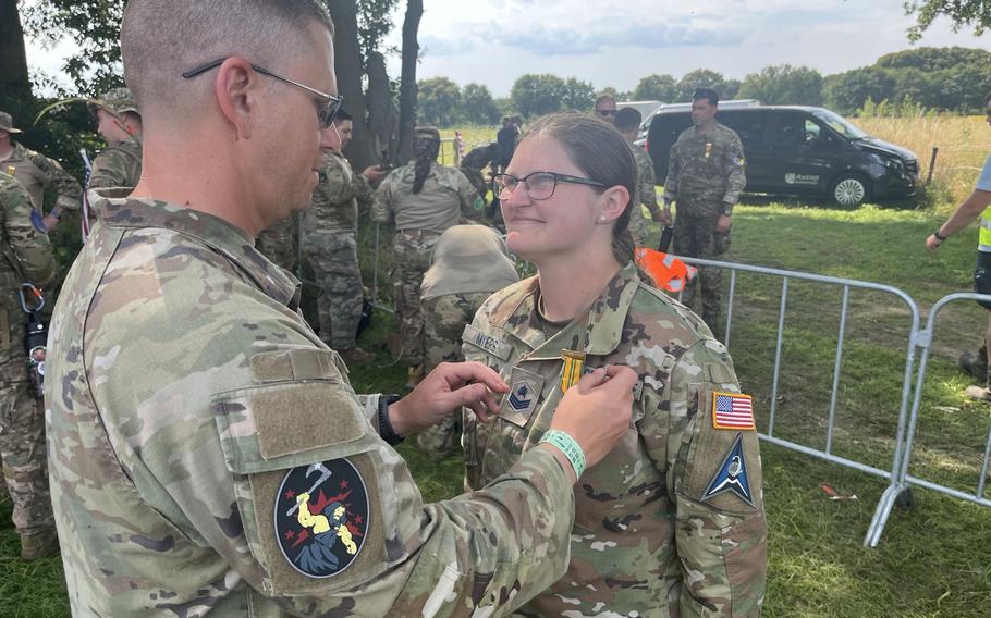 Space Force Senior Master Sgt. Robert Baer presents fellow guardian Sgt. Clara Myers.