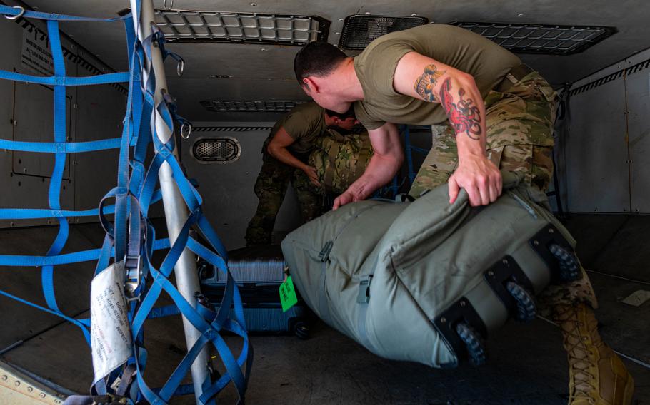 Team Minot Airmen pack luggage onto a passenger jet in preparation for exercise Agile Warbird at Minot Air Force Base, N.D., July 13, 2024. 