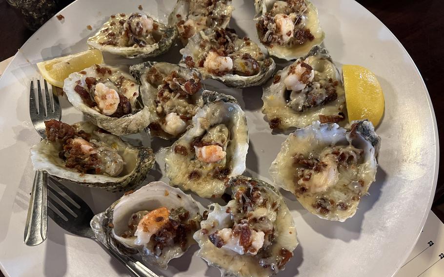 A plate of oysters called the Islander with bacon, shrimp and cheese at the Beach Pit. The Beach Pit is a cleverly named restaurant where a fusion of seafood and Texas-style barbecue is served. 