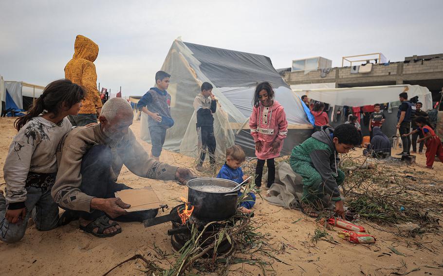 A family prepares food in the al-Mawasi area of Rafah in the Gaza Strip.