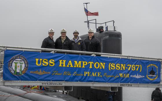 KITTERY, Maine (Nov. 21, 2024) — Captain Jason Deichler, Commodore, Commander, Submarine Squadron Two, left, Cmdr. Grant Wanier, commanding officer of the Los Angeles-class attack submarine USS Hampton (SSN 767), Tim Doyon, Hampton Project Superintendent, and Capt. Michael, Shipyard Commander, pose for a group photo Following the arrival Hampton at Portsmouth Naval Shipyard in Kittery, Maine, Nov. 21, 2024. While at the shipyard, Hampton will undergo essential repairs, and system upgrades critical to extending a submarine’s service life and ensuring the Navy’s long-term fleet readiness. As America’s leader for attack submarine maintenance, repair, and modernization, PNSY is enhancing critical warfighting capabilities by safely delivering first time quality service, on-budget, on time to the fleet and helping enable warfighters to be battle-ready when called upon. (U.S. Navy photo by Mass Communication Specialist 1st Class Charlotte C. Oliver)