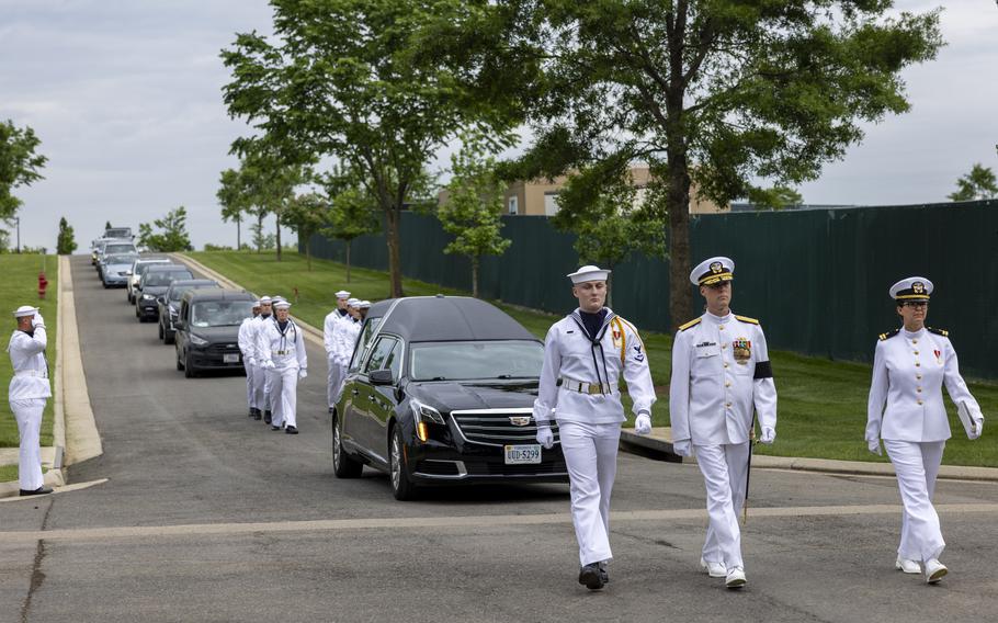 The U.S. Navy Ceremonial Guard, with the hearse carrying Navy Radioman 3rd Class Starring Brooks Winfield, marches down McClellan Road in Arlington National Cemetery on May 9, 2024.