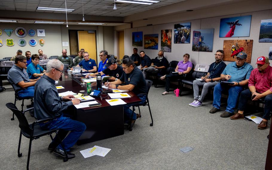 Sean Peterson, bottom left, leads a daily morning meeting at the National Interagency Coordination Center in Boise, Idaho. The increased fire activity in the United States has put the center on Preparation Level 5 by July for only the fourth time in 20 years.