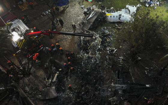 Firefighters and rescue workers work in the debris at the site where an airplane with 61 people on board crashed in Vinhedo, Sao Paulo state, Brazil, Saturday Aug. 10, 2024.