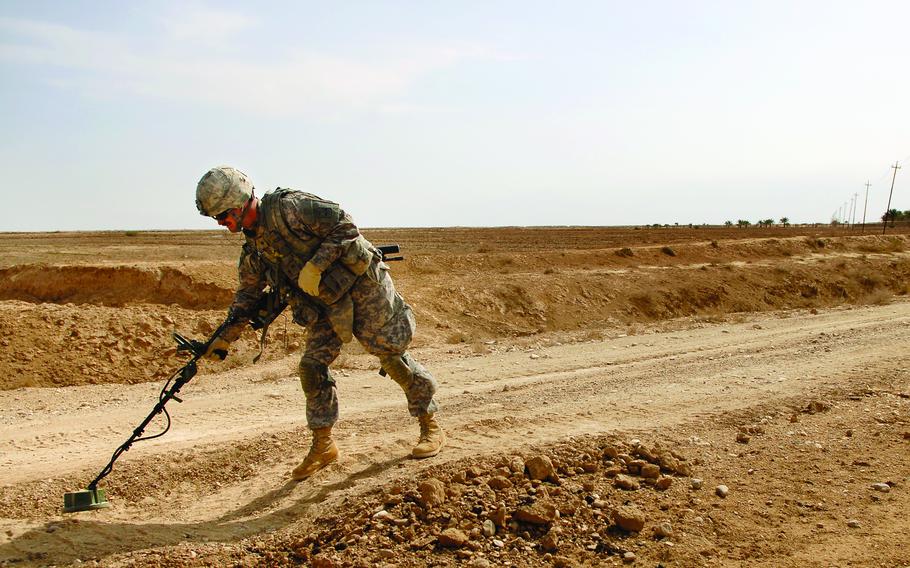 Spc. Benjamin Provost, a soldier from 3rd Platoon, Company A, Task Force 3-66 Armor, uses a mine detector during a patrol Feb. 19 in Tahweela, Iraq.  Mines have become a major concern for coalition and Iraqi security forces in this area.  