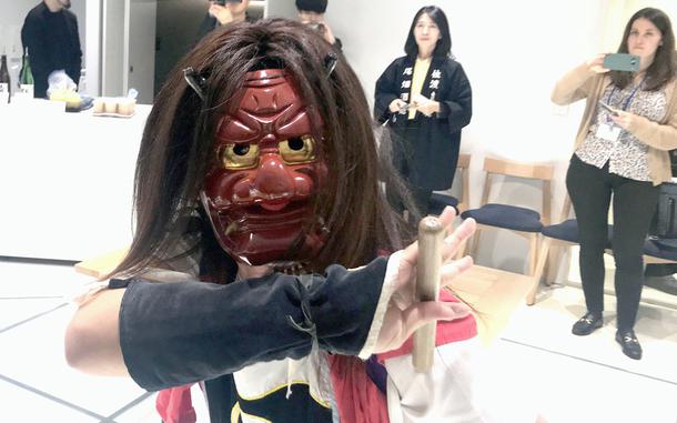 A traditional performer from Sado Island in Niigata prefecture, Japan, shows off his moves in Tokyo’s Ginza district, Nov. 26, 2024. 