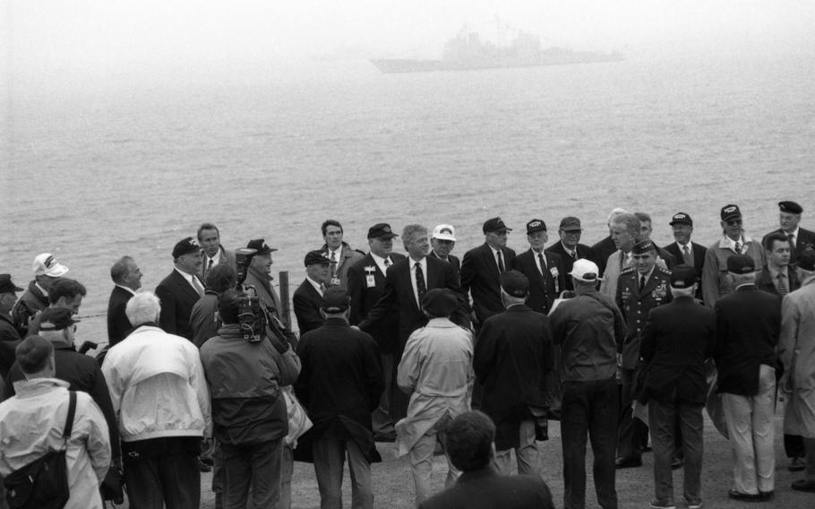 President Bill Clinton talks to D-Day veterans at the ceremony commemorating the D-Day landing at Pointe du Hoc, France, near Omaha Beach. The gathered crowd included many U.S. Ranger veterans who scaled the 100-foot cliffs to knock out the German artillery overlooking the landing beaches.