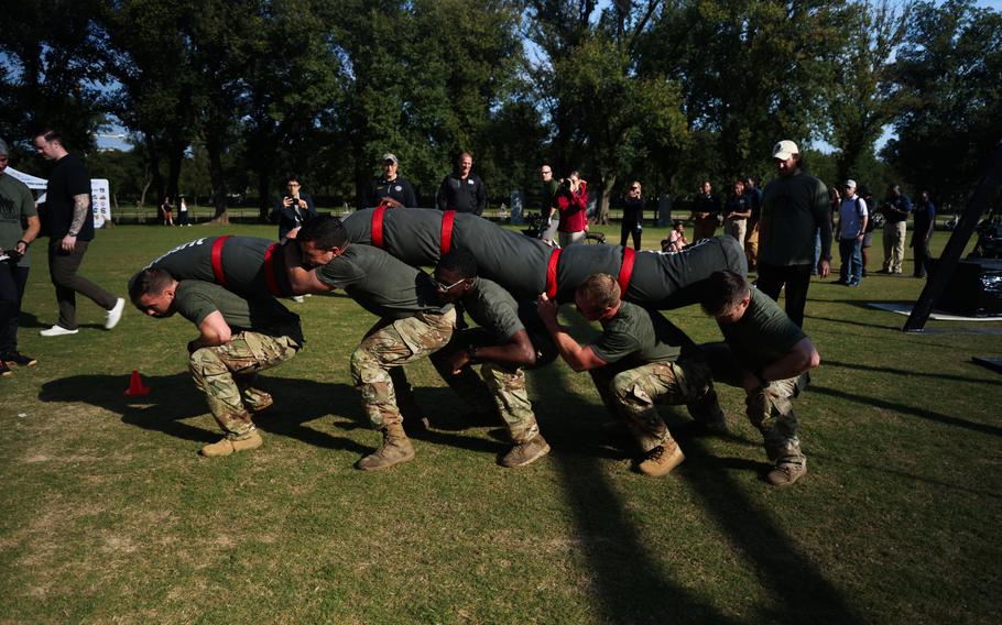 Five U.S. Army Soldiers representing the U.S. Army Futures Command squat and collectively carry 405 Ibs over their shoulders for the Army Best Squad Competiton 2024.