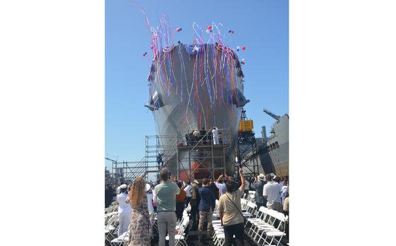 Military Sealift Command's newest fleet replenishment oiler, USNS Lucy Stone (T-AO 209), slides down the rails, and into the San Diego Bay, following its christening at the General Dynamics NASSCO shipyard in San Diego, Calif., today.