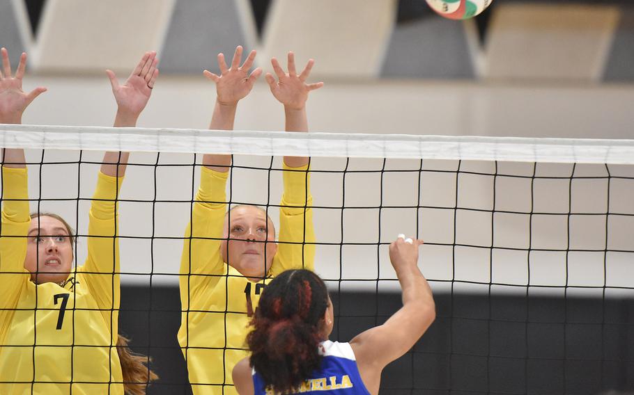 Sigonella's Nyeema Fernandez manages to get the ball past the Vicenza wall of Alexandra Nelson, left, and Avonlea Sparling on Friday, Sept. 13, 2024, in Vicenza, Italy.