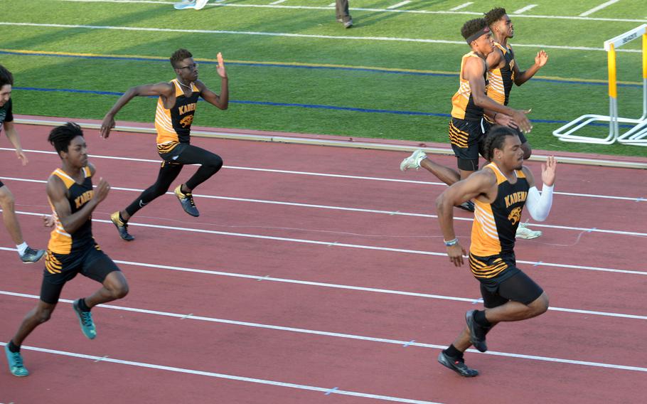 Kadena's D'Kylan Woods leads the pack in the 100-meter dash during Saturday's second day of a two-day Okinawa track and field meet. Woods won the event in 11.79 seconds.