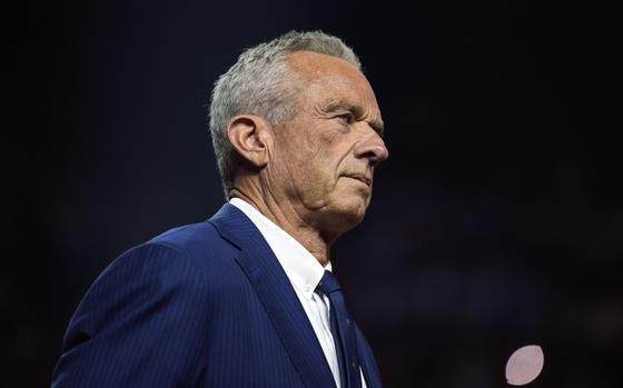 FILE - Independent presidential candidate Robert F. Kennedy Jr. listens before endorsing Republican presidential nominee former President Donald Trump at a campaign rally at the Desert Diamond Arena, Friday, Aug. 23, 2024, in Glendale, Ariz. (AP Photo/Evan Vucci, File)