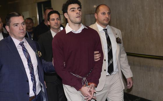 Luigi Mangione is escorted into Manhattan Criminal court for his arraignment on state murder and terror charges in the killing of UnitedHealthcare CEO Brian Thompson, Monday, Dec. 23, 2024, in New York. (AP Photo/Seth Wenig)