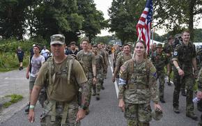 Maj. William Watts and Sgt. 1st Class Kerstan Harrivel lead the U.S. Army Europe and Africa team near Overasselt, Netherlands during the Four Days March Nijmegen on July 19, 2024. The team completed about 100 miles of marching over four days.