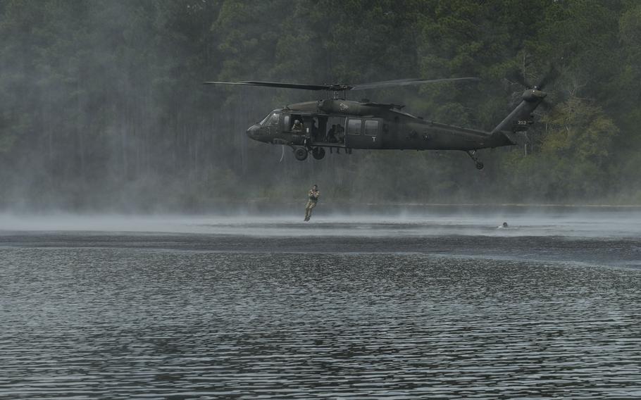 A U.S. Army Soldier helocasts from a UH-60 Black Hawk during the Army Best Squad Competition at Fort Liberty, N.C., Oct. 4, 2024. 