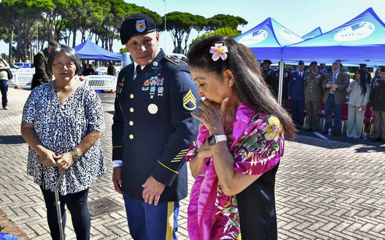 Yoko Sakato, left, and Valerie Matsunaga, right, relatives of soldiers who fought in the 442nd Infantry Regiment during the World War II, are flanked by U.S. Army Staff Sgt. Michael A. Rosado, as they attend a commemoration at the U.S. military base of Camp Darby, Tuscany, central Italy, Thursday, July 11, 2024. The 442nd Infantry Regiment, known as the Nisei Regiment, was composed almost entirely of second-generation American soldiers of Japanese ancestry, who fought primarily in Europe, particularly in Italy, southern France and Germany.